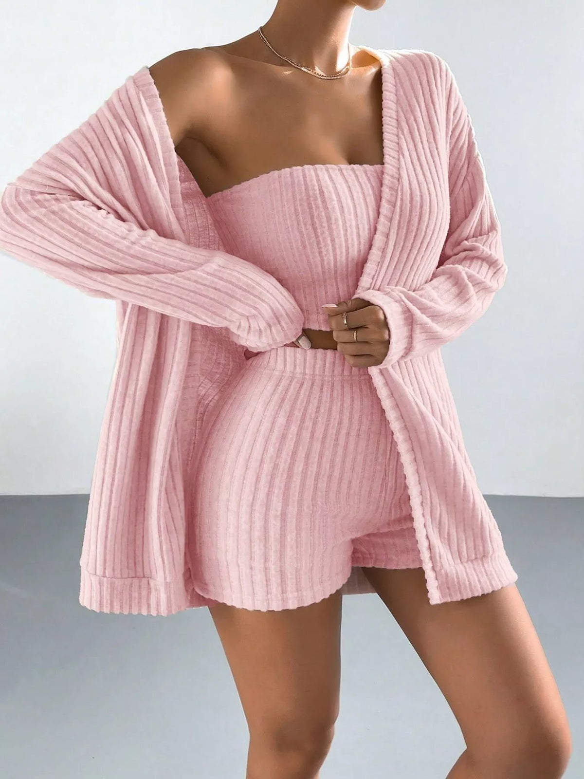 Women's three-piece ribbed knit outfit with long-sleeve open-front cardigan, strapless tube top and matching high-waisted shorts.