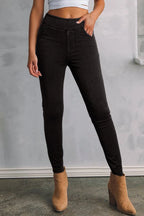 Women's black stretch skinny jeans with fitted legs, classic black denim finish and functional pockets.