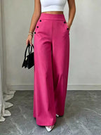 Women's high-waisted wide-leg dress pants with decorative button accents, side pockets and flowing silhouette.