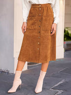 Women's caramel button-front midi skirt with metallic-look buttons, two front patch pockets and seam detailing.