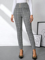 Women's black and gray plaid high-waisted slim-fit pants with decorative button accents and tailored silhouette.