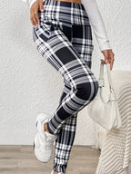 Women's high-waisted plaid slim-fit leggings with fitted silhouette, slight stretch and pockets.