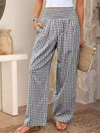 Women's gingham plaid wide-leg casual pants featuring a smocked elastic waistband, relaxed silhouette and functional pockets.