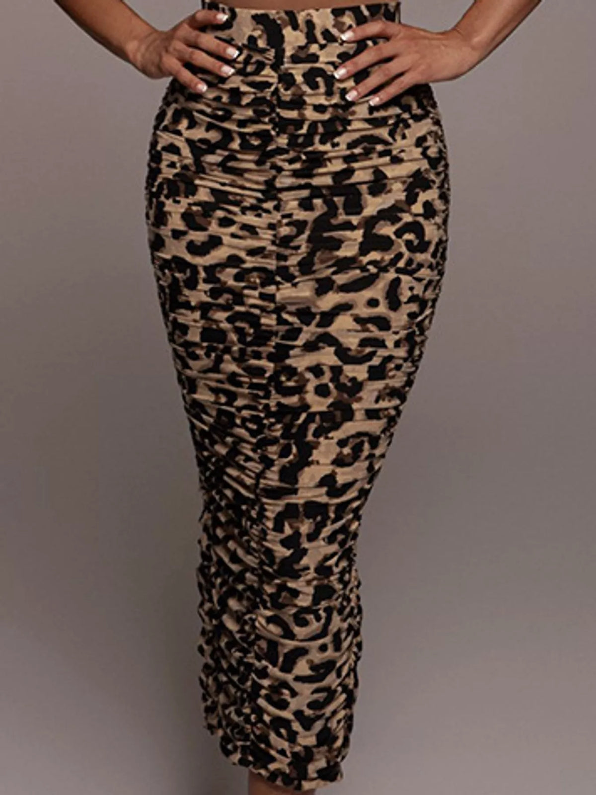 Women's leopard print high-waisted ruched maxi skirt with fitted bodycon silhouette and side slit.