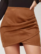 Women's camel brown high-waisted ruched bodycon mini skirt with asymmetrical wrap-look front.