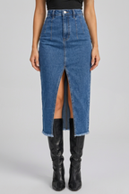 Women's high-waisted blue denim skirt collage highlighting the front slit, raw hem and fitted denim silhouette.