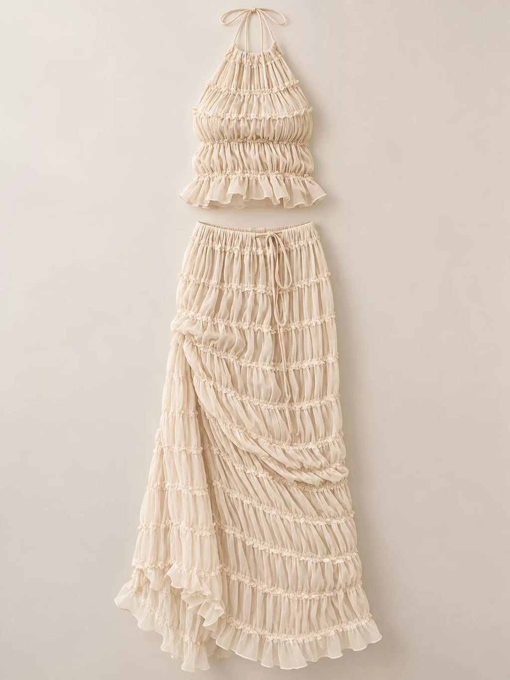 Women's boho two-piece outfit with ruffled halter crop top, open-back tie details and flowing tiered maxi skirt.