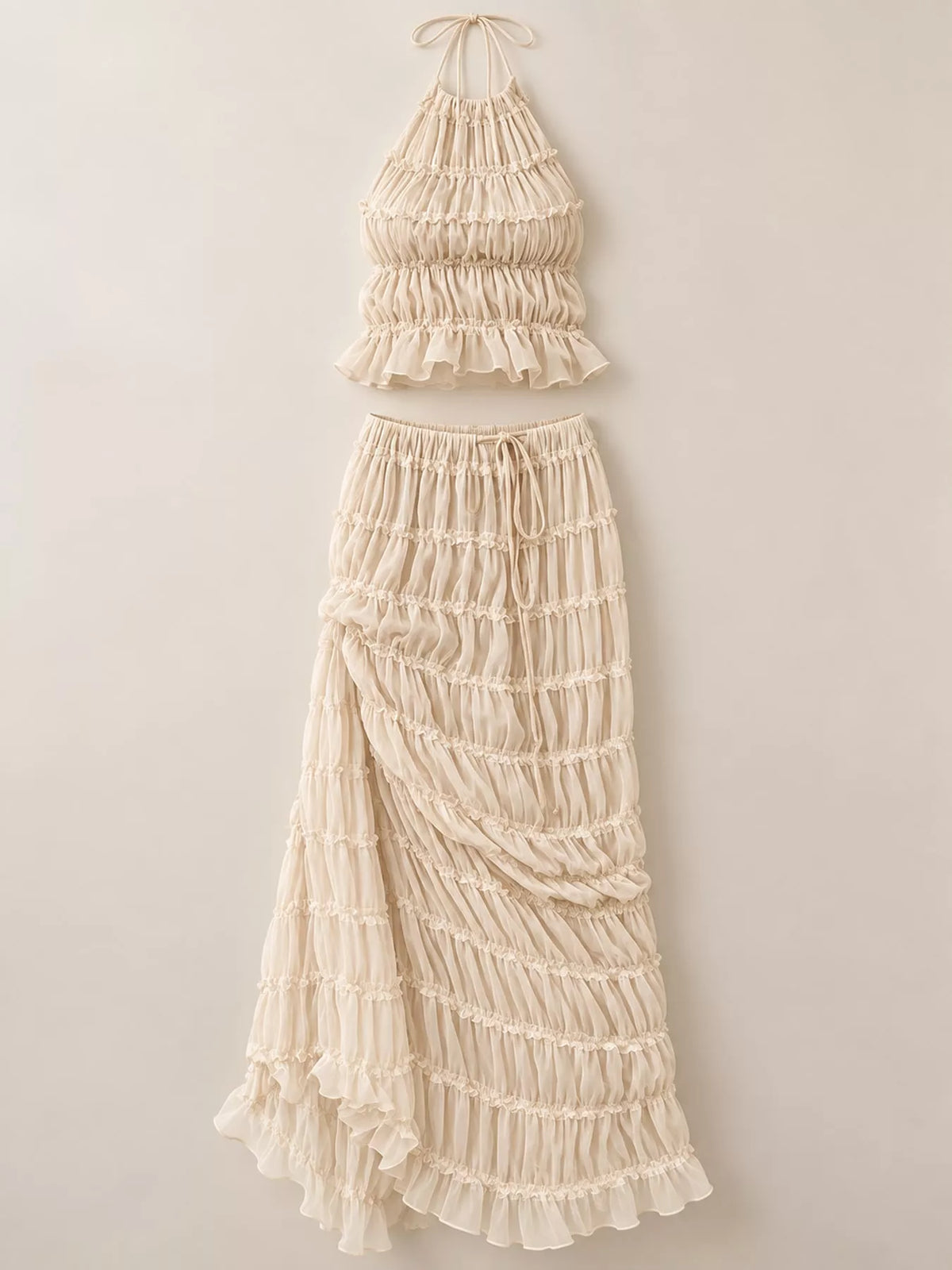 Women's boho two-piece outfit with ruffled halter crop top, open-back tie details and flowing tiered maxi skirt.