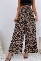 Women's leopard print high-waisted wide-leg pants with flowing legs and relaxed silhouette.