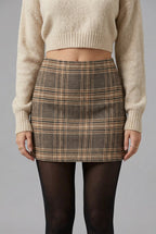 Women's khaki plaid high-waisted A-line mini skirt with classic check pattern and flared silhouette.