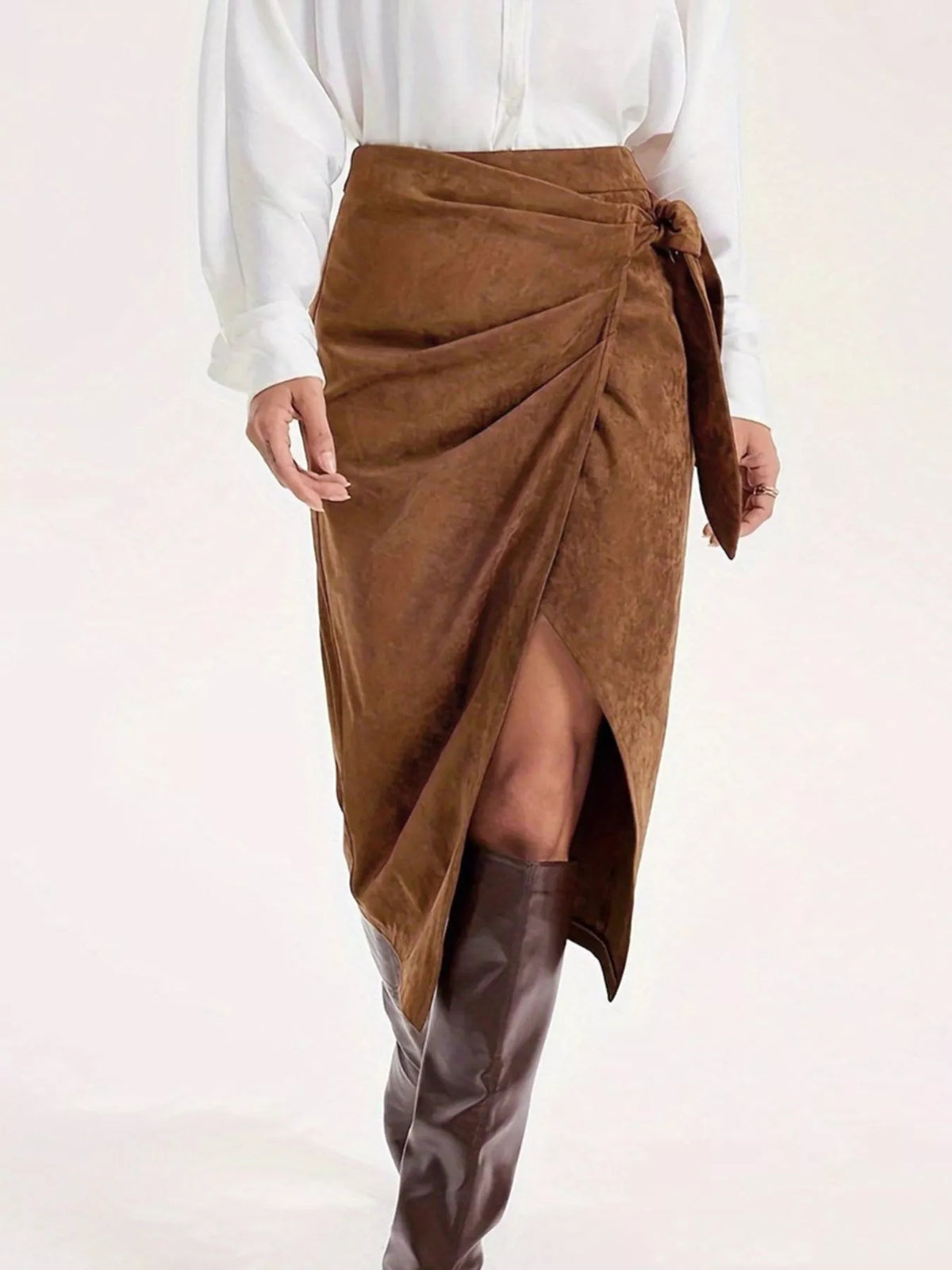 Women's brown wrap-style midi skirt featuring an elegant side tie, side slit and draped silhouette.