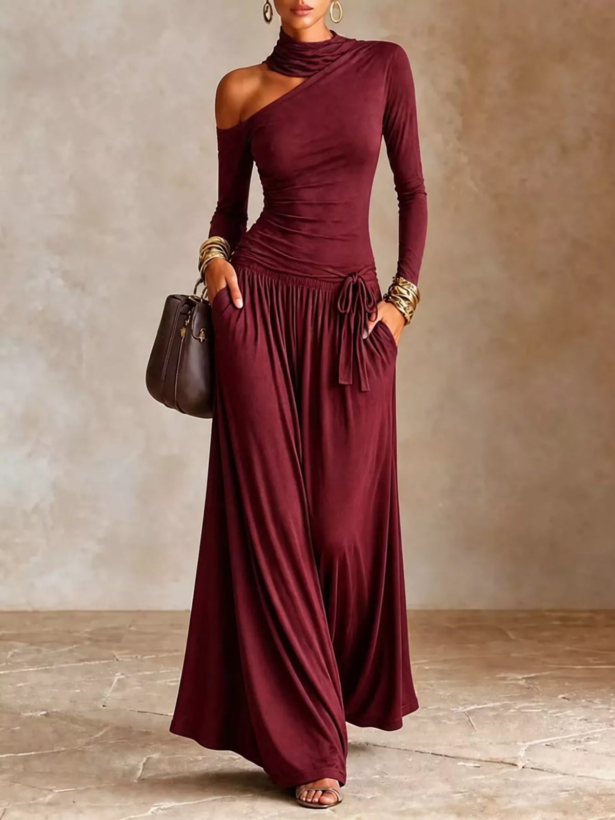 Women's long-sleeve maxi dress with asymmetrical shoulder cutout, high neckline, adjustable drawstring waist and side pockets.
