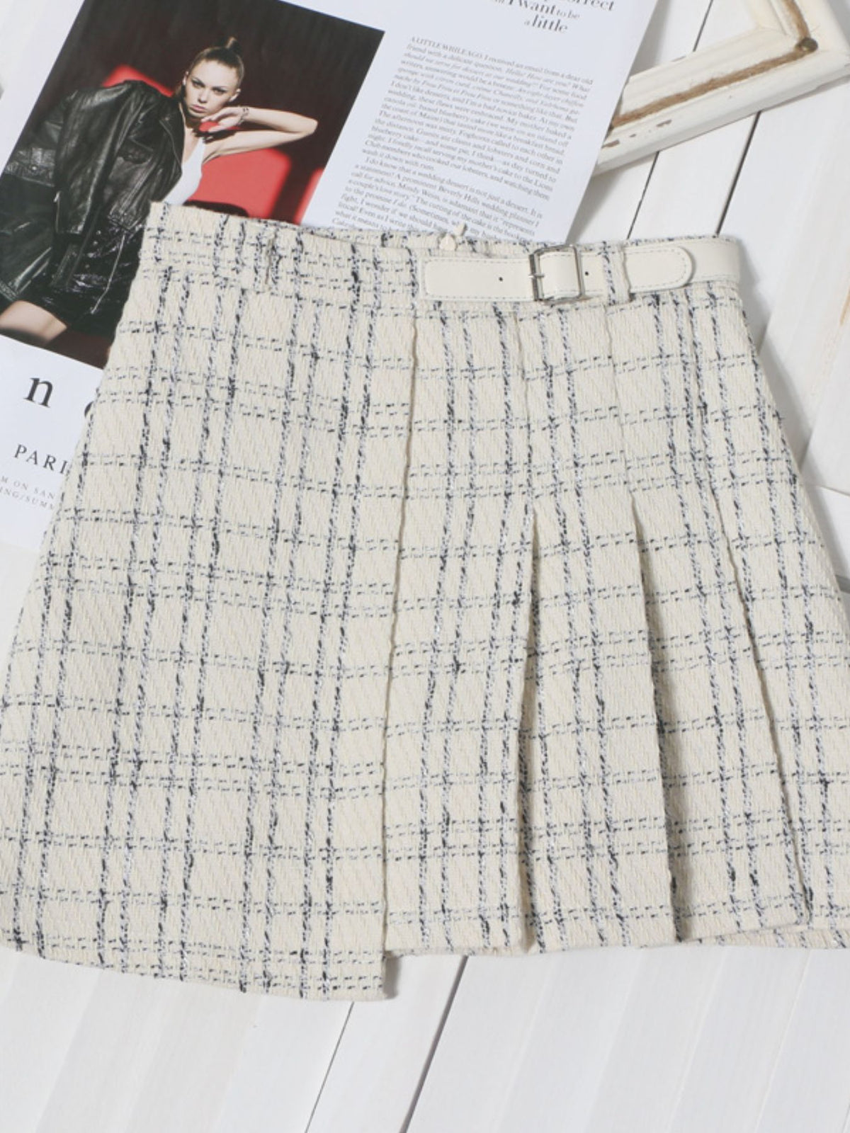 Women's pleated plaid mini skirt with ruched detailing, stylish slit and preppy-inspired design.